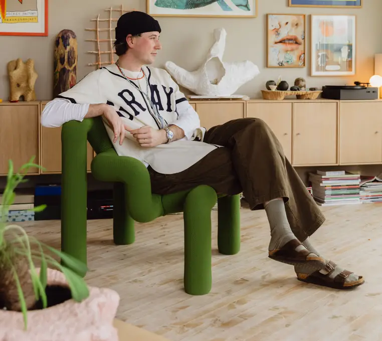 Hipster Man Socks and Slides Sitting on Green Ekstrem
