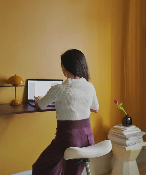 woman using move stool at computer