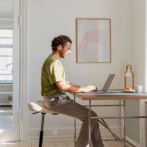 man using move stool at computer